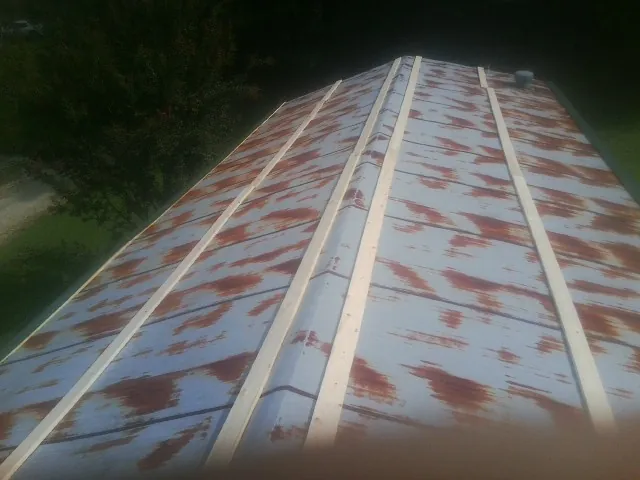Rusted metal roof panels with new wood purlins before replacement — Storm Damage Roof Repair in Deposit by Roofing Brothers